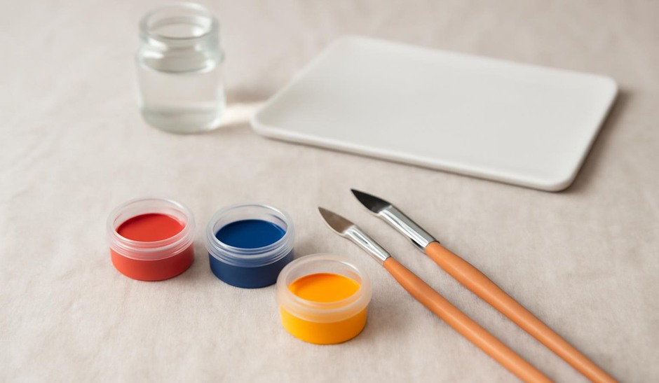 A small selection of paints and brushes organised neatly